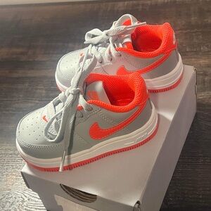 Brand: Nike (Air Force 1)
Color: Grey with crimson accents
Condition: NEVER WORN